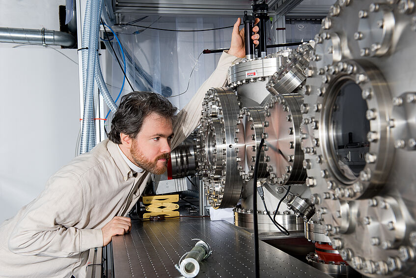 A researcher looking at equipment in a lab.