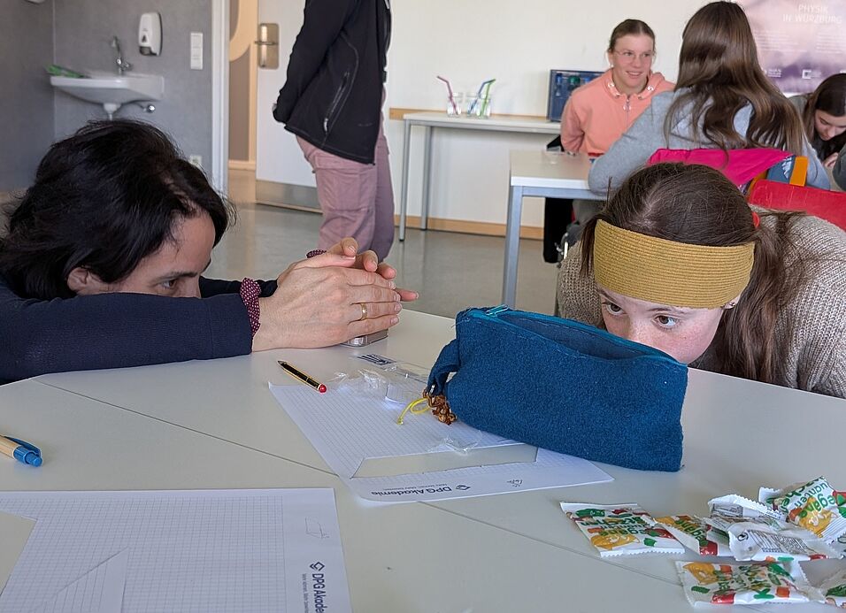 Adriana Pálffy-Buß and a girl a looking curiously at their pseudo-holograms.
