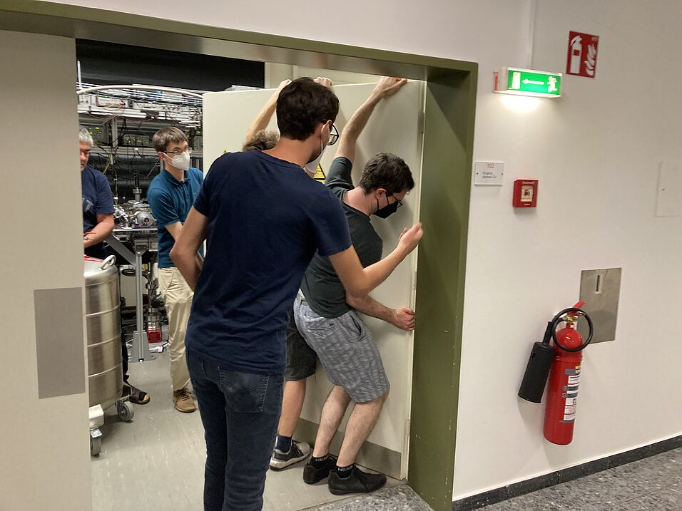 Disassembling a door to move some of the equipment through.