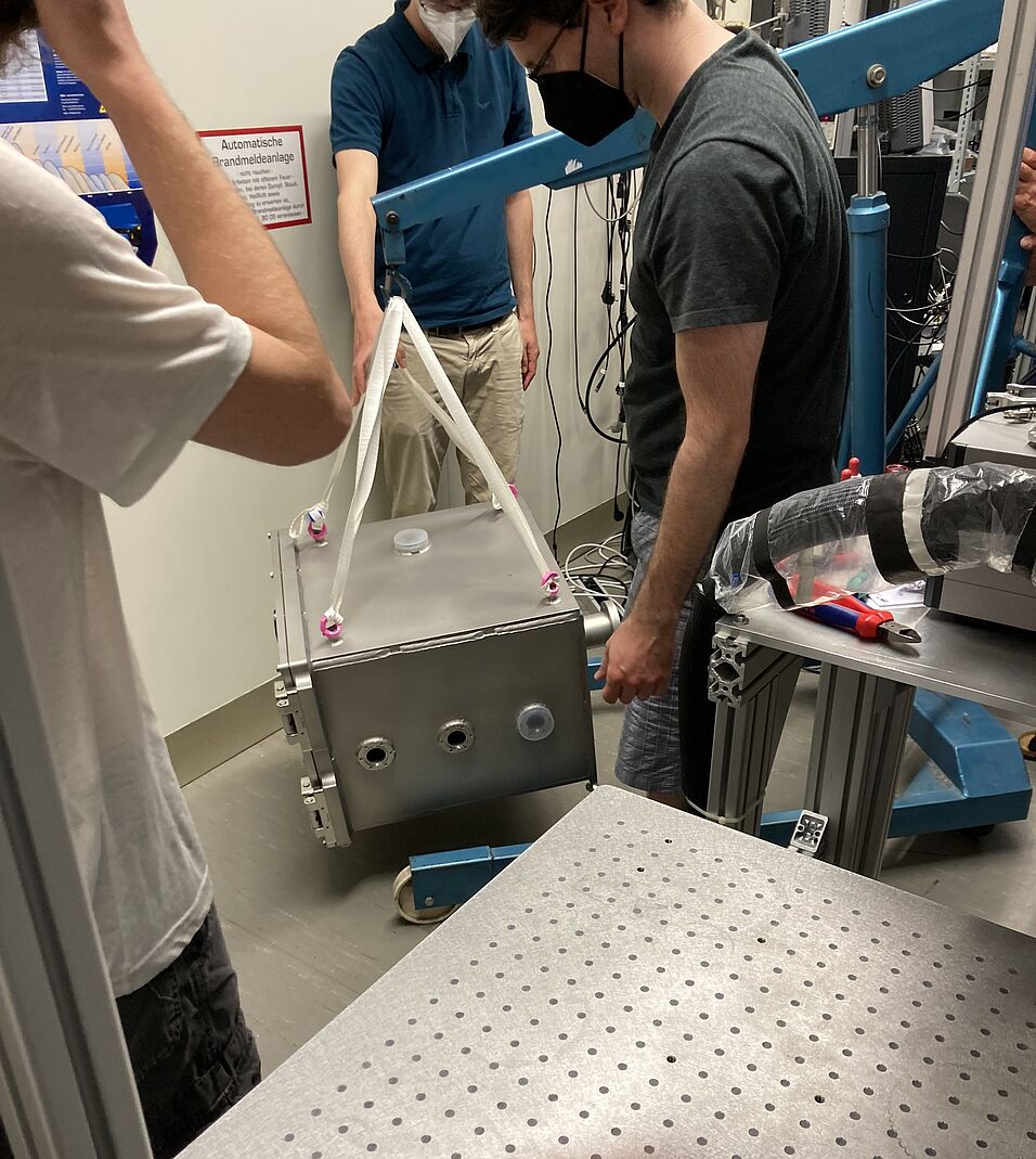 People moving some of the lab equipment.