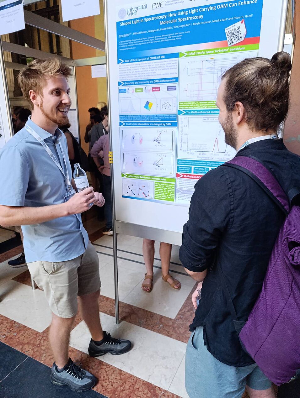 Scientists discussing a poster.