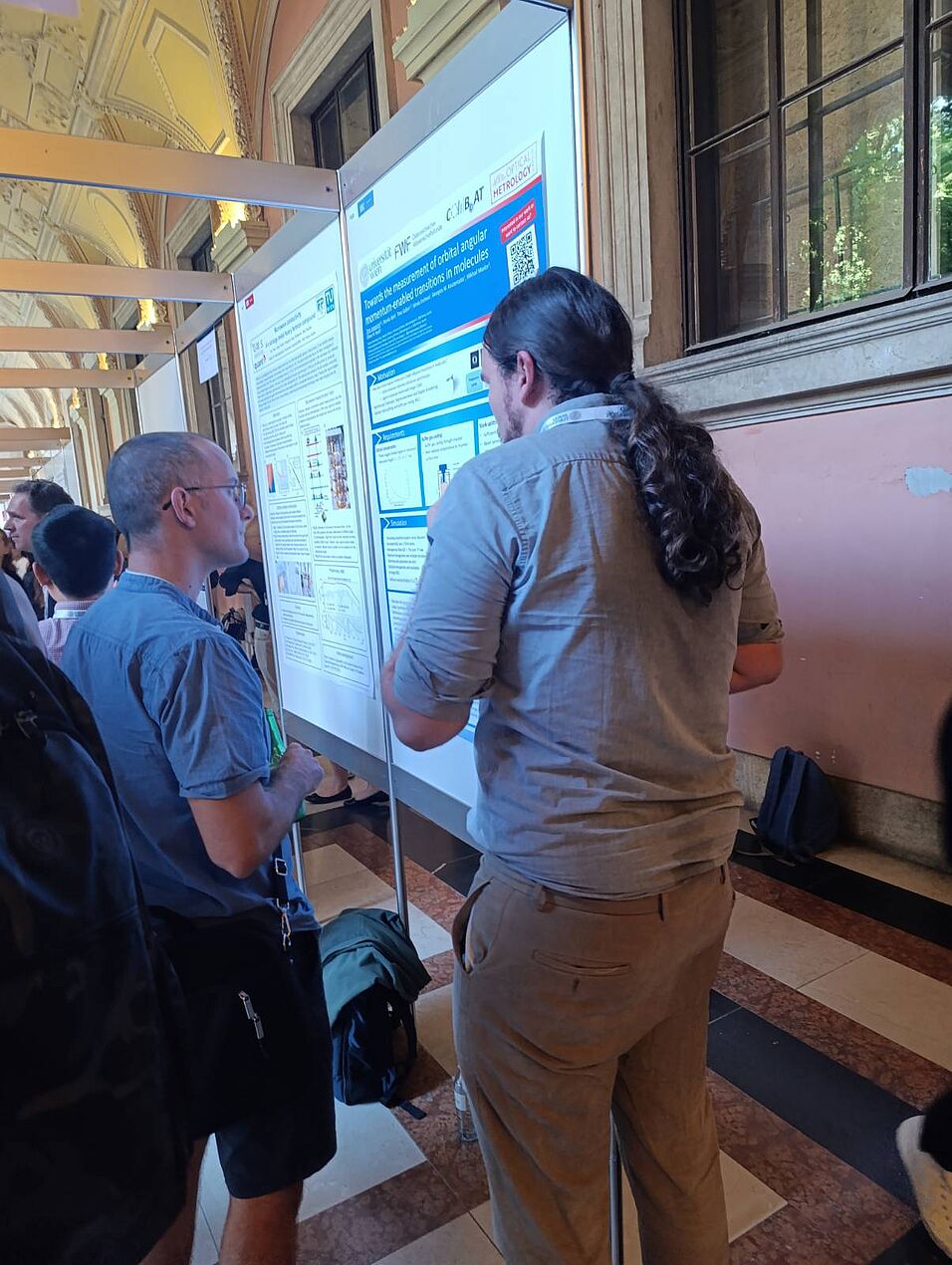 Scientists discussing a poster.